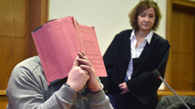 (FILES) This file photo taken on February 26, 2015 shows German former male nurse Niels H hiding his face behind a folder as he waits next to his lawyer Ulrike Baumann (R) for the opening of another session of his trial on February 26, 2015 at court in Oldenburg, northwestern Germany. 
The German male nurse jailed for life two years ago for killing two patients with lethal drug overdoses is now a suspect in at least 84 more murders, police said on August 28, 2017.
 / AFP PHOTO / DPA / CARMEN JASPERSEN