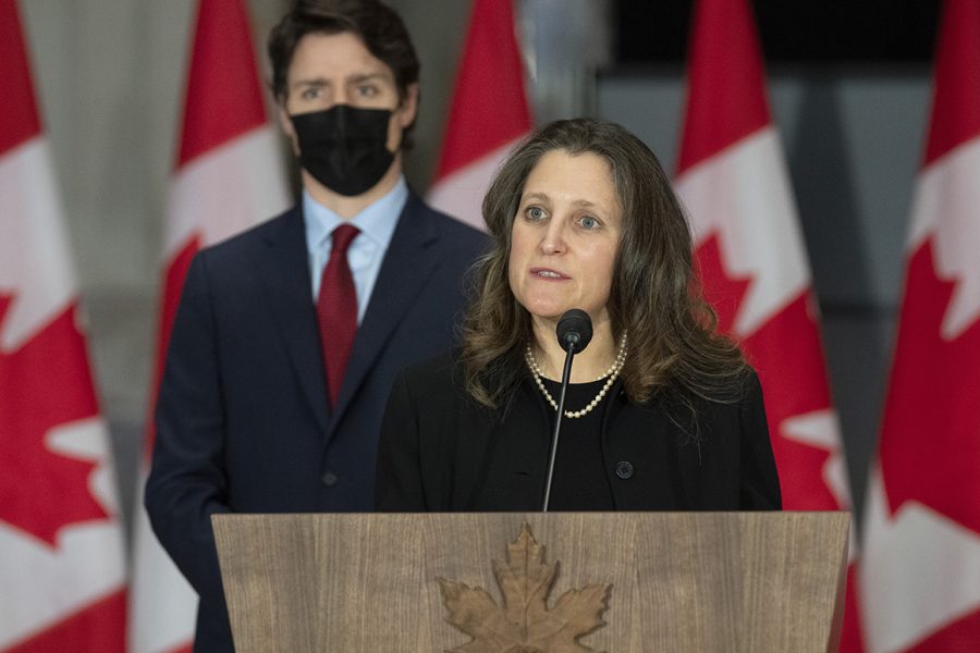Canadian Prime Minister Justin Trudeau looks on as Deputy Prime Minister and Finance Minister Chrystia Freeland speaks during a news conference, Thursday, Feb. 24, 2022 in Ottawa.  (Adrian Wyld/The Canadian Press via AP)